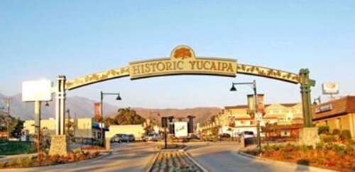 Photo of a street with the City of Yucaipa sign on top